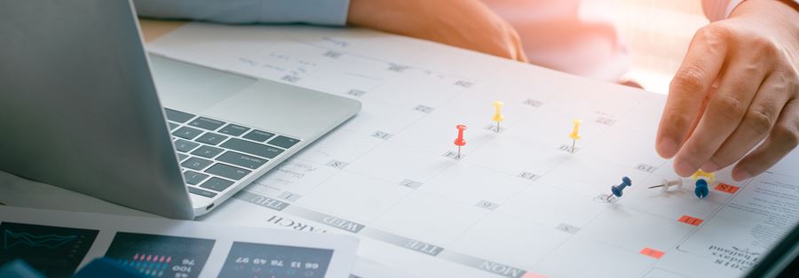 A man with a computer checking his calendar